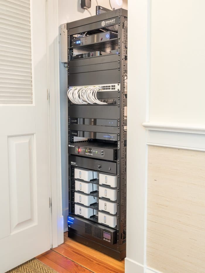 Tidy equipment rack installed in a closet, with labelled components and cable management